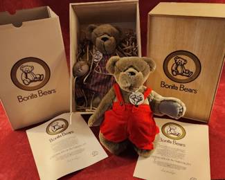 Bonita Bears collectible teddy bear in red overalls, displayed alongside its original packaging and certificate of authenticity