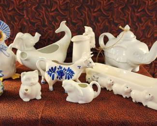 Overview Visual Matches Pages with this image Solve This photograph shows an assortment of Victorian and later ceramics, including teapots, jugs, and animal-shaped vessels in white and blue glazes
