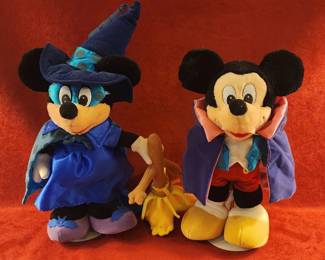 Mickey Mouse dressed in Halloween costumes, one as a sorcerer and the other as a witch
