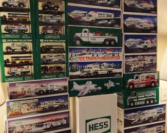 Boxed Hess Trucks miniature vehicles, including fire trucks, ambulances, and helicopters, arranged in a grid pattern