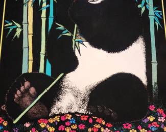 This vintage poster features a giant panda sitting among tall bamboo stalks, holding a bamboo stalk in its paw, with colorful flowers at its feet