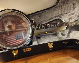 Banjo with a decorative image of a dog and an American flag on its resonator