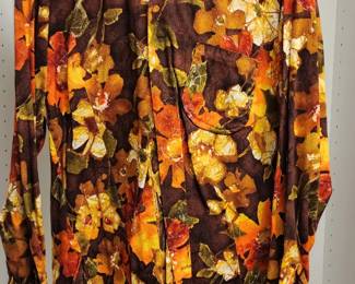 Vintage button-down blouse featuring a bold floral print in shades of orange, yellow, and green