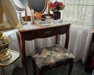 vanity table, makeup, perfumes, and mirror