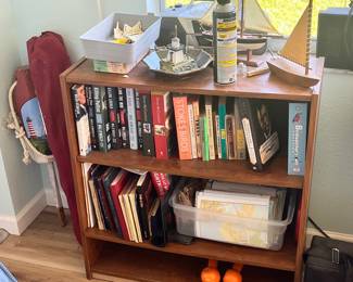 Wooden Bookshelf with Assorted Books and Decorative Items