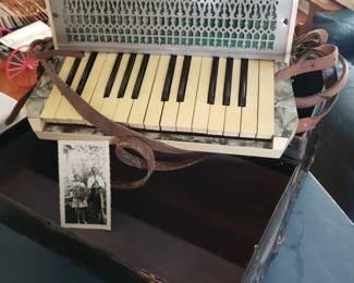 Antique accordian with photo of original owner