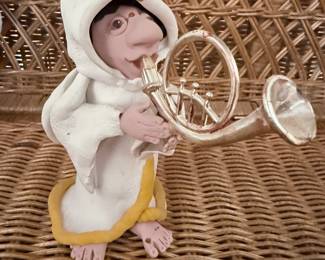 Figurine of a creature playing a French Horn