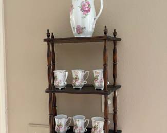 Tea set on vintage hanging shelf.