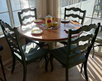 French ladder back chairs w/ 2 toned round to oval pedestal table.