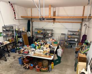 Garage space filled with workroom, cleaning, crafting, camping, etc. 