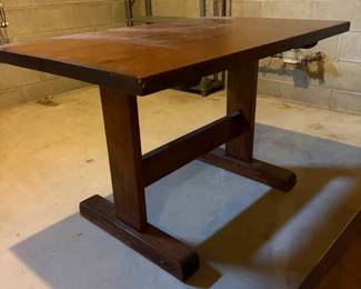 Solid top trestle base table. 