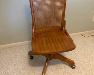 Cane backed oak 4 pt. swivel bankers chair.