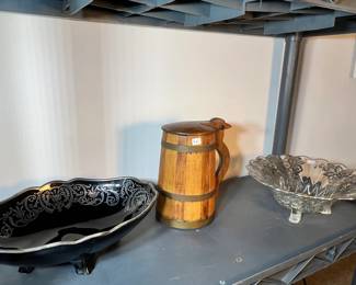 Ornate silver-trimmed black glassware shown alongside a vintage wooden tankard