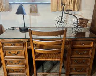 Classic executive wooden desk with a glass top, paired with a matching ladder-back chair