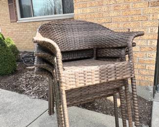 Stack of dark brown resin-wicker all-weather patio armchairs