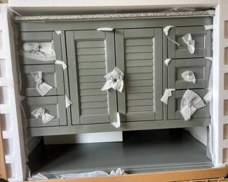Brand new in package Grey Hamilton bath vanity with granite top, shown partially uncrated