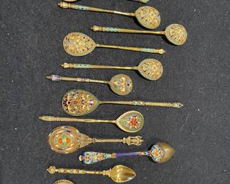 Collection of antique Russian-style cloisonné enamel spoons, featuring intricate filigree work and multi-colored floral patterns in pristine condition
