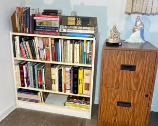 White bookcase filled with an extensive collection of Christian theology and biblical reference books