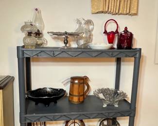 Display shelf featuring ruby red cranberry glass, etched crystal, and miniature rustic chairs