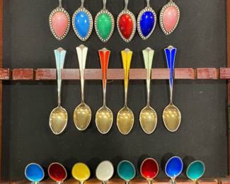 A magnificent showcase of Norwegian David-Andersen sterling silver demitasse spoons featuring vibrant jewel-toned guilloché enamel