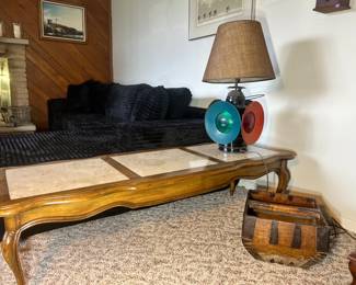 Long wood-framed coffee table with three inset marble panels and elegant cabriole legs
