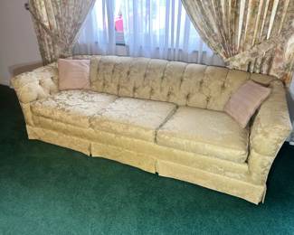Luxurious Victorian-style tufted sofa in a shimmering champagne damask fabric