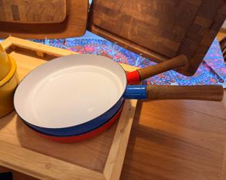 Selection of vintage Dansk enamel cookware and wood cutting boards.  The red fry pan has a large spot of enamel loss to the bottom