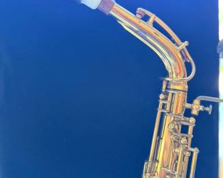Vintage Buescher 140 Aristocrat Series III Alto Saxaphone on a display stand.  The original case will be included but is not photographed
