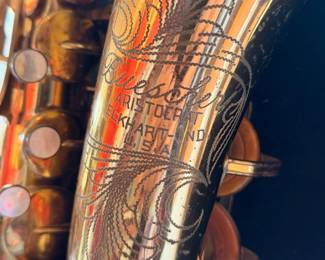 Vintage Buescher 140 Aristocrat Series III Alto Saxaphone on a display stand.  The original case will be included but is not photographed