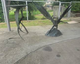 Outdoor garden art.  Beautiful decorative birdbath and winged fairy like creature.