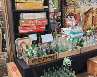 lots of vintage soda bottles and cases