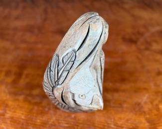 This lot features an original soapstone sculpture that’s believed to be by listed Cree artist, Howard Moose. Minor chipping throughout shown in photos and signed by Howard underneath. This sculpture measures, 9” H x 5.5” W x 5.5” D. Born in 1966, Moose began carving at age eight and transitioned from wood to stone mediums like soapstone and alabaster.