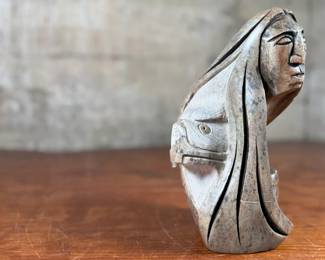 This lot features an original soapstone sculpture that’s believed to be by listed Cree artist, Howard Moose. Minor chipping throughout shown in photos and signed by Howard underneath. This sculpture measures, 9” H x 5.5” W x 5.5” D. Born in 1966, Moose began carving at age eight and transitioned from wood to stone mediums like soapstone and alabaster.