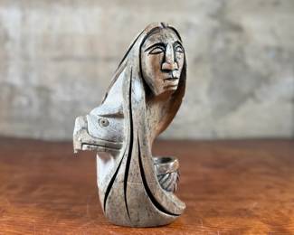 This lot features an original soapstone sculpture that’s believed to be by listed Cree artist, Howard Moose. Minor chipping throughout shown in photos and signed by Howard underneath. This sculpture measures, 9” H x 5.5” W x 5.5” D. Born in 1966, Moose began carving at age eight and transitioned from wood to stone mediums like soapstone and alabaster.