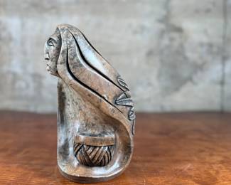 This lot features an original soapstone sculpture that’s believed to be by listed Cree artist, Howard Moose. Minor chipping throughout shown in photos and signed by Howard underneath. This sculpture measures, 9” H x 5.5” W x 5.5” D. Born in 1966, Moose began carving at age eight and transitioned from wood to stone mediums like soapstone and alabaster.