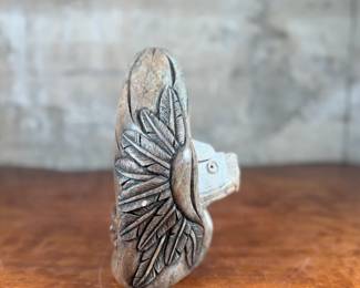 This lot features an original soapstone sculpture that’s believed to be by listed Cree artist, Howard Moose. Minor chipping throughout shown in photos and signed by Howard underneath. This sculpture measures, 9” H x 5.5” W x 5.5” D. Born in 1966, Moose began carving at age eight and transitioned from wood to stone mediums like soapstone and alabaster.