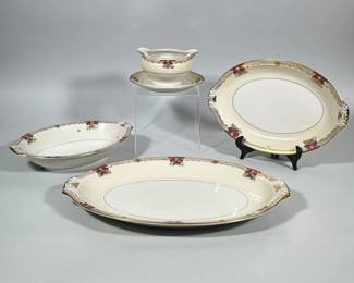 (4pc) NORITAKE SAVONA IVORY CHINA SERVEWARE, GRAVY BOAT AND PLATTERS | Group includes a gravy boat with attached underplate, a small platter, a large platter (17.5 x 11.5 in.), and a bowl. Ivory ground with gilt rim banding and magenta cartouche-style accents with small floral sprays; molded handle/terminal details on platters. Backstamp on underside reads “Empire Shape / Metto China / Savona” with “Ivory China” and a secondary script “Made in Occupied Japan.” Gilded rims and the pattern border are visible on all pieces.