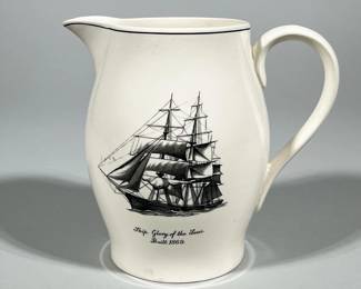 COPELAND SPODE ENGLAND TRANSFERWARE SHIP PITCHER, 'GLORY OF THE SEAS' | White earthenware pitcher with a black transfer-printed three-masted sailing ship and printed script reading "Ship Glory of the Seas. Built 1869." Features a single black line around the rim and a matching black line down the center of the handle. Base bears a printed "COPELAND / SPODE / ENGLAND" backstamp with a hand-applied or inscribed pattern number "F1144."