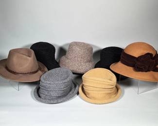 (7pc) Wool Hats | Group of wool felt women's hats including a camel cloche with brown velvet band and rosette appliqués, a tan felt fedora with stitched leather band, and assorted grey and black felt cloche styles. The camel cloche measures 13 in. diameter. The tan fedora shows an interior woven label reading "Callanan Millinery — European Designer / American Style." Brims include piped edges and the fedora features a tied leather hatband with stitched detailing.