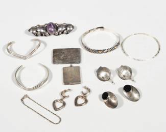 (11pc) STERLING SILVER JEWELRY GROUP | Including a Mexican sterling silver brooch with leaf details and center-set with a large amethyst (or other purple) cabochon stone (l. 3.25 in.), four silver hard bracelets [thinnest bangle is unmarked], a sterling chain bracelet (l. 7.25 in.), three pairs of sterling post earrings [one unmarked], and two square locket pendants [the smaller with 'Ruth" engraved to front, the other unmarked], with fineness marks unless otherwise noted; 4.8 ozt total lot weight