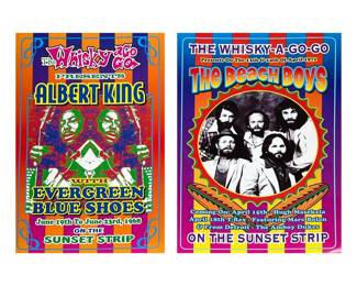 COPELAND SPODE ENGLAND TRANSFERWARE SHIP PITCHER, 'GLORY OF THE SEAS' | Two color concert posters printed on paper, each featuring psychedelic striped backgrounds and bold headline lettering reading "The Whisky-A-Go-Go." One poster names ALBERT KING with a mirrored, high-contrast portrait and text indicating "June 19th To June 23rd, 1968;" the other names THE BEACH BOYS with a circular black-and-white band portrait and dates referencing April 1971. Both show bright spot-color printing and border rule lines; publisher/credit text is printed along the bottom edge. Each item appears to be a modern offset/poster print reproduction rather than an original gig handbill.