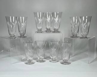(11pc) ETCHED STARBURST CORDIAL GLASSES | Set of eleven clear glass cordial glasses with a slightly flared conical bowl raised on a short stem and round foot. Each glass is decorated with an etched starburst motif and small star accents around the bowl. Thin polished rims and smooth circular bases are visible in the photographs. 