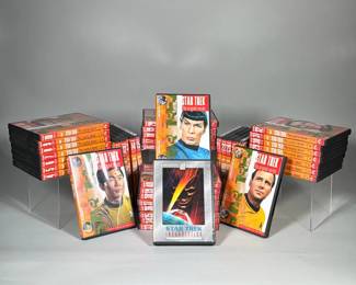 (2pc) ROYAL DOULTON 'IMPERIAL PALACE' (CHEN CHI) DINNER PLATE AND 'SAYURI AND CHILD' (EDNA HIBEL) SALAD PLATE | Group of Star Trek DVDs comprising numbered orange-spined volumes 1–40 of Star Trek: The Original Series in plastic cases and a Star Trek: Insurrection Special Collector's Edition widescreen DVD. Volume cases feature portrait artwork of original series cast members and visible volume numbers on the spines; several volumes appear shrinkwrapped. The Insurrection disc is housed in a full-size case with a silver 'Widescreen Collection' border and front cover art. Packaging indicates the television volumes were digitallly enhanced and remastered.