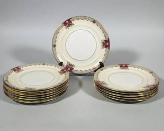(12pc) MEITO-CHINA 'SAVONA' IVORY CHINA SALAD PLATES | Group of ivory-colored porcelain salad plates with gilt outer rim and single gilt inner band; rim decorated at intervals with magenta/pink foliate cartouches and gilt scrollwork. Underside bears printed backstamp reading "EMPIRE SHAPE MEITO-CHINA SAVONA" with red script "Ivory China" and a printed "Made in Occupied Japan" marking. Plates have a slightly scalloped rim and recessed center. Dimensions: 