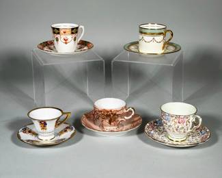 (10pc) MIXED SET OF DEMITASSE CUPS & SAUCERS INCLUDING ROYAL STAFFORD & AYNSLEY | Lot of five assorted porcelain demitasse cups and saucers with gilt rims and painted floral decoration. Forms include a flared footed cup with repeated floral sprays, a cylindrical cup with swag motif and gilt handle, and a scalloped pink cup with applied gilt relief. Includes Royal Stafford and Aynsley pieces. Largest saucer diameter: 5 in.