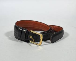COACH LEATHER BELT WITH BRASS BUCKLE | Black leather belt with tan leather interior, single-prong rectangular brass buckle and two stitched keeper loops. Interior is blind-stamped with "COACH", model number "5763" and the word "BLACK" along with additional manufacturing text. Belt has stitched edges and a rounded tip.