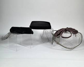 (3pc) LOT OF THREE VINTAGE VEILED FASCINATORS, BLACK VELVET, PLEATED SATIN AND BROWN CORD | Group of three vintage women's veiled fascinators. Includes a black velvet pillbox-style fascinator with velvet bows and attached birdcage netting and internal criss-cross sweatband; a black padded headband-style piece with accordion-pleated satin top and short veil; and a brown cord-loop fascinator with wide birdcage net. All pieces are constructed with millinery netting/veiling and fabric trims, and show typical interior hatband/sweatband construction.