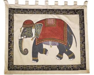 INDIAN SILK PAINTING OF AN ELEPHANT | A painting of an elephant in red garb with its trunk down, executed in gouache or similar medium on silk with gilt highlights, within a decorative floral background