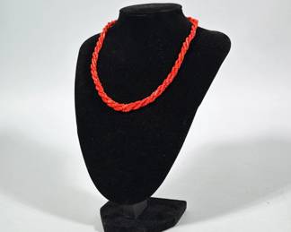 RED CORAL CHIP BRAIDED NECKLACE WITH STERLING SILVER CLASP | Braided necklace composed of small red coral chip beads and tiny round spacer beads twisted into a rope form. Clasp is a floral-design box clasp stamped "STERLING" on the reverse. Beads appear polished and exhibit irregular twig-shaped and short cylindrical pieces along the strand.