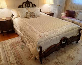 Queen size bed with carved wood headboard and footboard.  The two small nightstands are NOT FOR SALE.